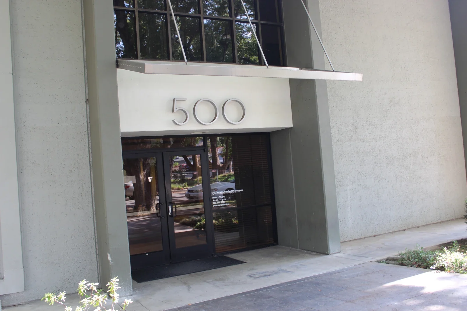 Gateway entrance with glass doors and exterior walkway.