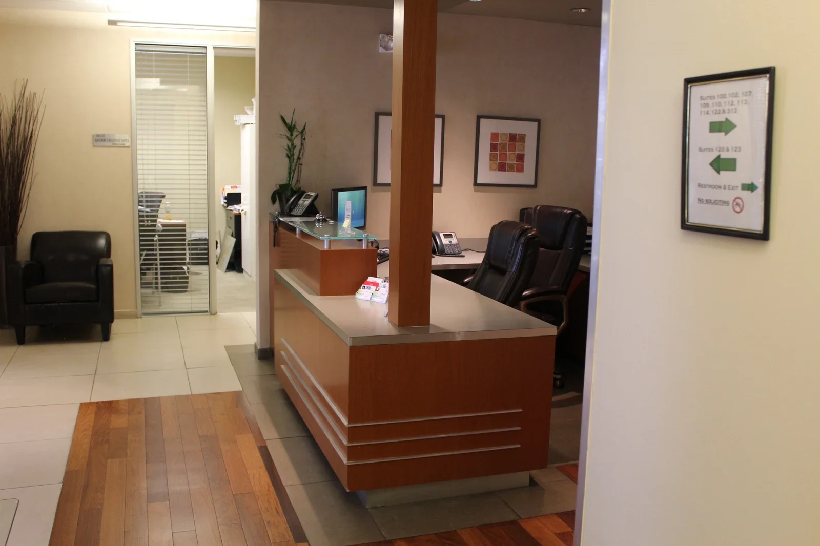 Reception counter and office corridor with waiting chairs.
